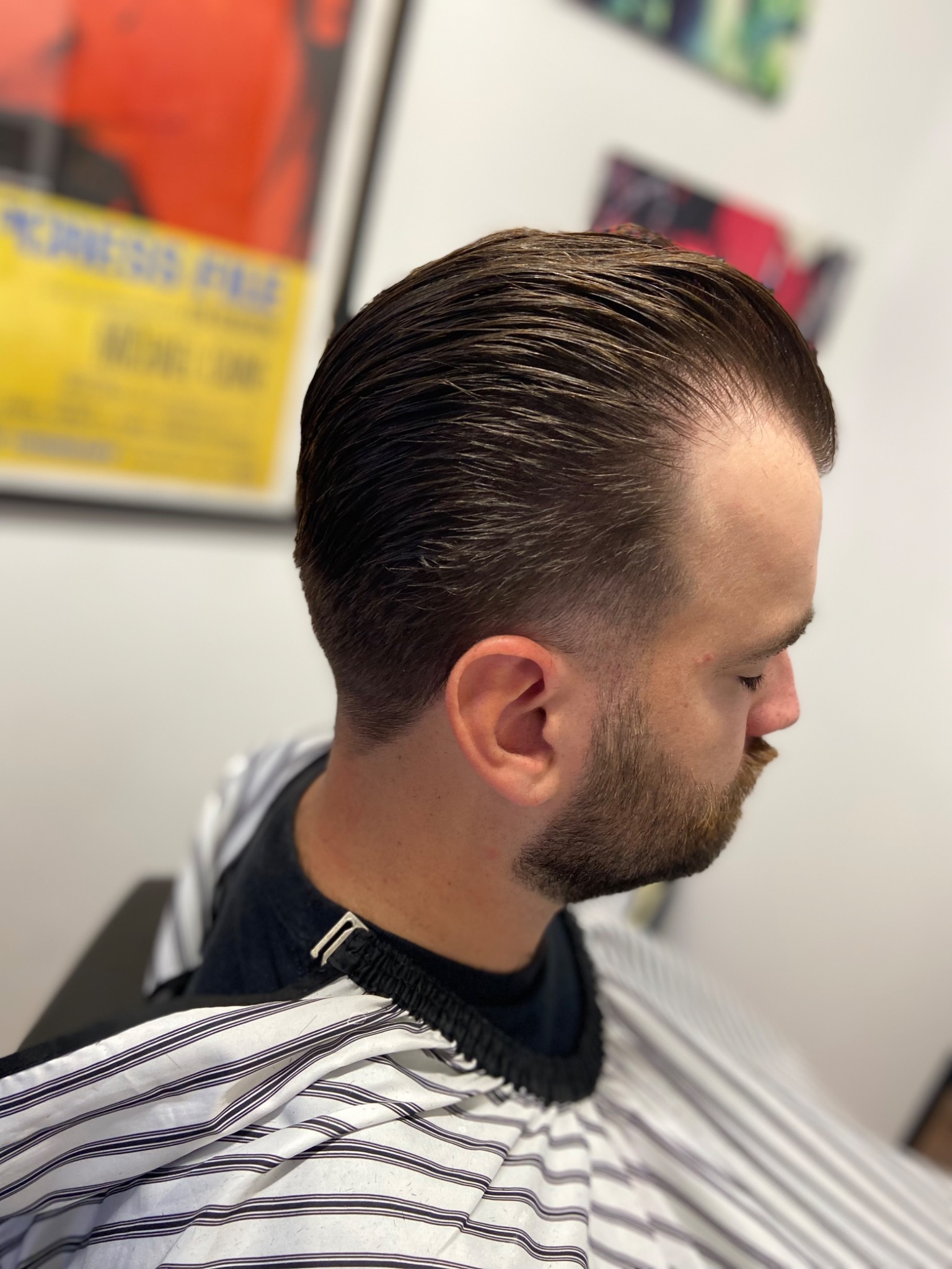 Classic slicked-back haircut by The Velvet Blade Barbershop